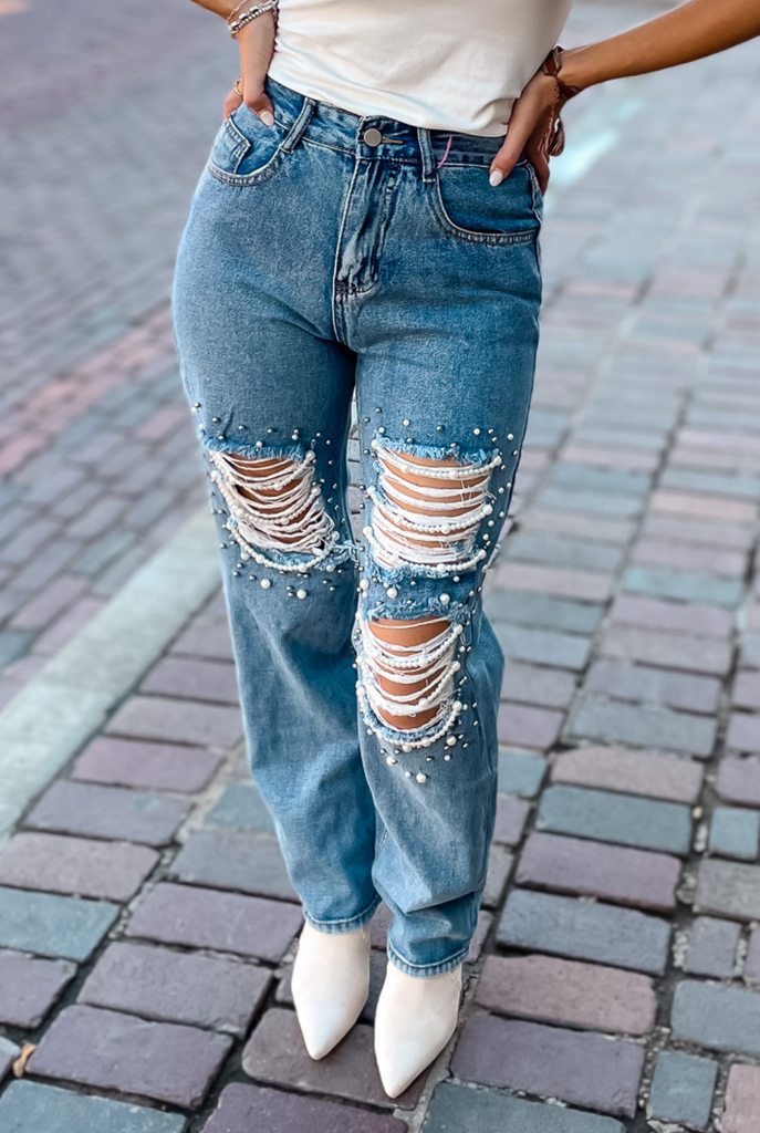 Ripped jeans with store pearls on them